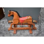 A modern wooden Rocking Horse on traditional swing action base