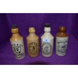 A selection of transfer printed earthen ware ginger beer bottles