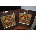 Two framed antique tiles depicting a variety of fruit.