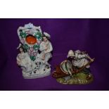 A Staffordshire flack back style watch holder and similar figurine by Kunst Baveria