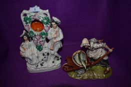 A Staffordshire flack back style watch holder and similar figurine by Kunst Baveria