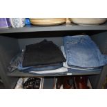 Thirteen pairs of jeans mainly Levi, and a Wrangler denim gillet with tags attached.