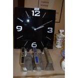 A black glass clock and three grab handles or similar.