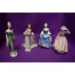 A selection of figurines of ladies in dress including Royal Doulton