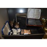 A metal deed box or tin with an assortment of vintage boxed cutlery, including cake forks, also