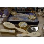 An assortment of vintage dressing table items including brushes, trinket boxes and candle stick
