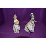 Two figurines by Lladro girl holding oranges and girl with umbrella