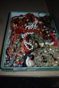 A mixed box of costume jewellery.