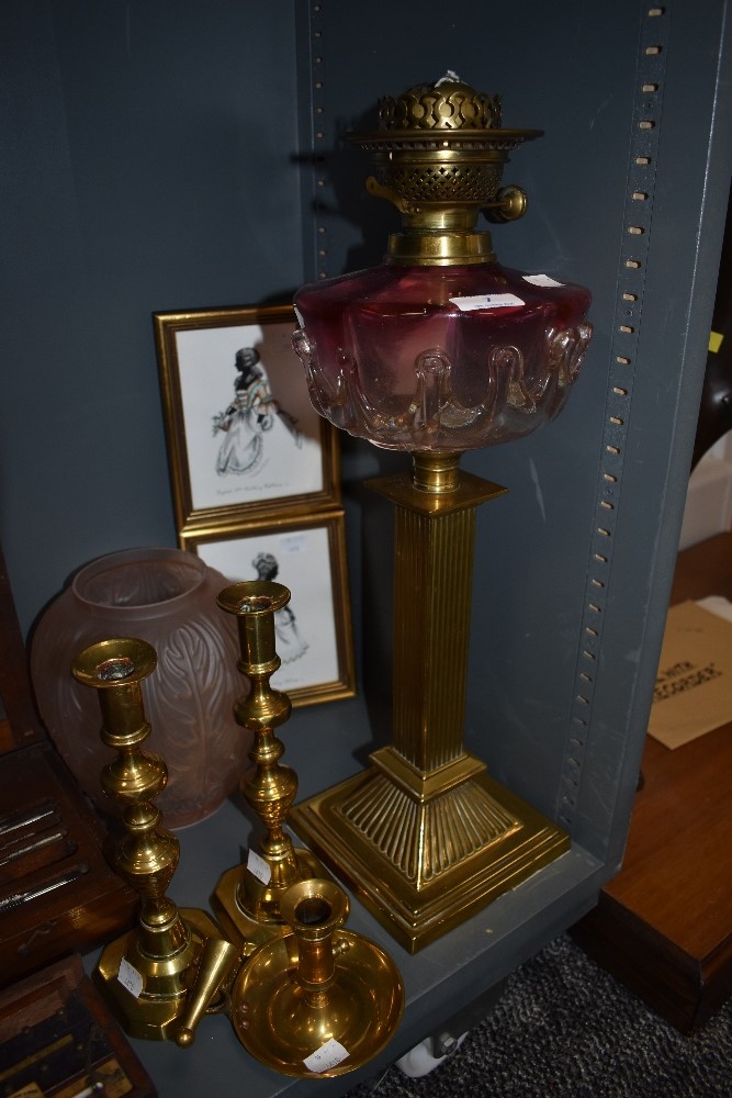 An impressive Victorian oil lamp having hand blown well with graduated cranberry glass also