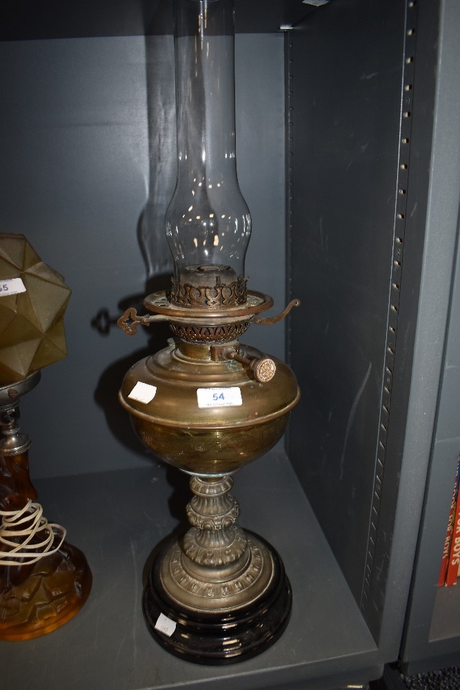 An oil burning lamp having ceramic base with decorative brass body