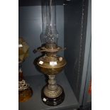 An oil burning lamp having ceramic base with decorative brass body