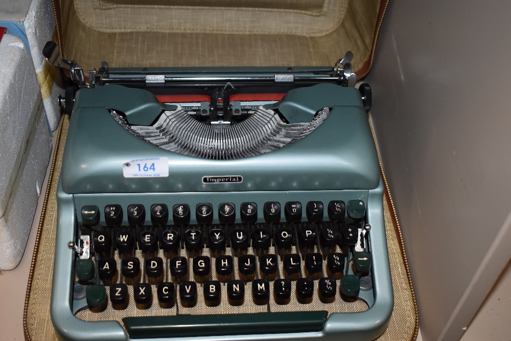 A cased Imperial Good Companion typewriter in metallic green