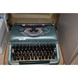 A cased Imperial Good Companion typewriter in metallic green