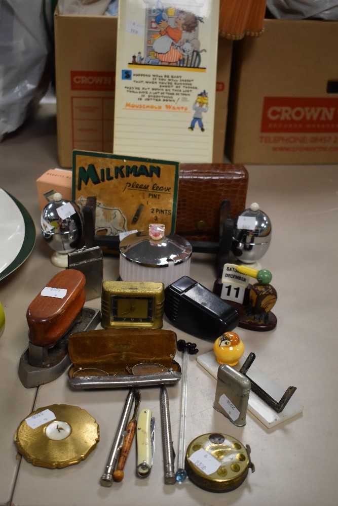 A selection of curios and collectables including art deco desk top calendar cigarette lighter and