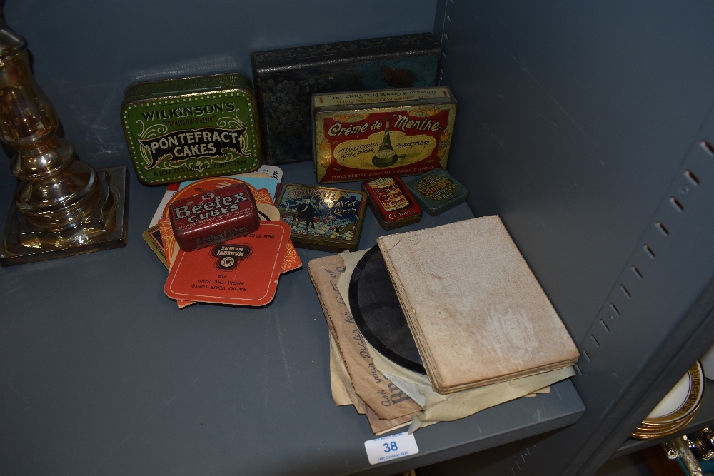 A selection of advertising tins and childrens shellac 78rm records