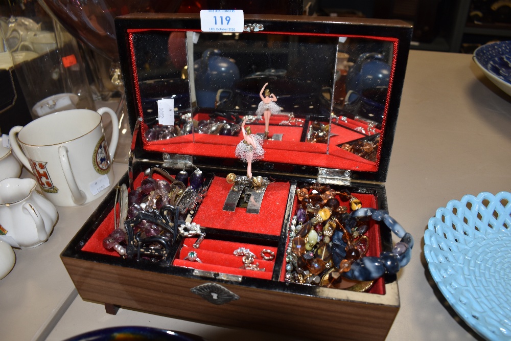 A musical jewellery box having ballerina to centre and mirrored back, containing a selection of