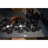 A selection of cameras, lenses and tripod including Praktica LTL3, Praktica LTL, Minolta Dynax 60