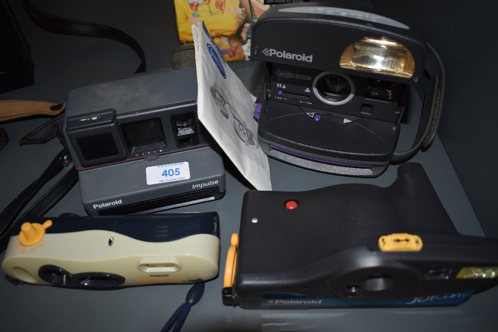 Four Polaroid cameras including Polaroid Cool Cam, Polaroid Impulse, Polaroid Joy Cam and Polaroid I