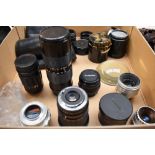 A box of various lenses including Ina 35mm, Mitakon Zoom 80-205mm, Chinon 50mm, Helios-44, Mertar