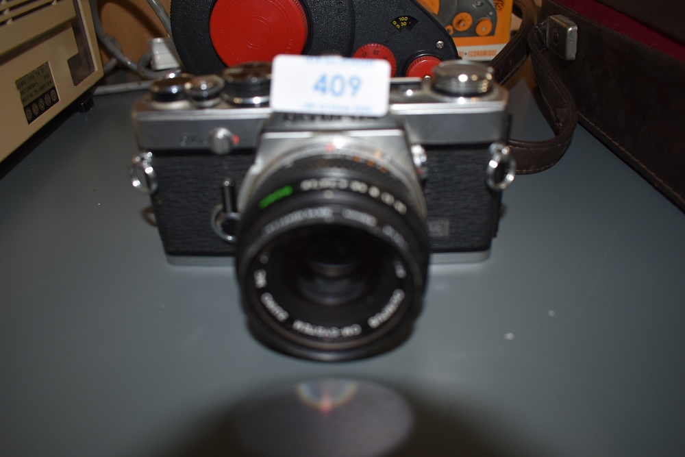 An Olympus OM-2n with 50mm lense
