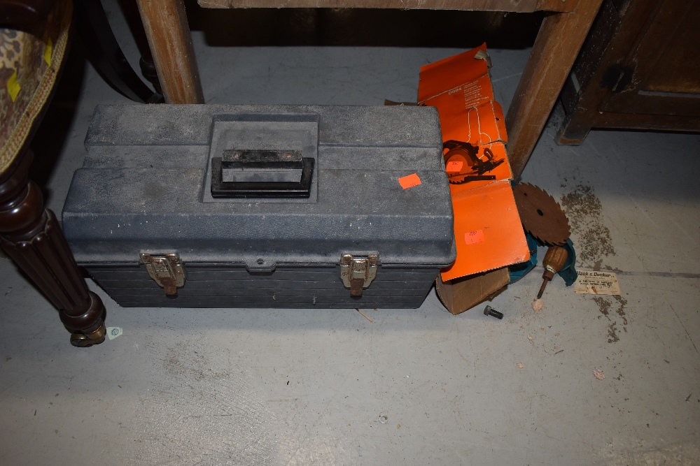 A toolbox and contents including Black and Decker power saw parts