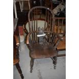 A traditional windsor armchair, in need of restoration