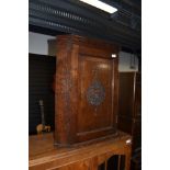 An oak corner cupboard of small proportions, having engraved front, L & R (M?)