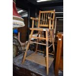 A vintage wood frame childs metamorphic high/low chair
