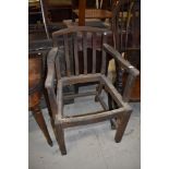 A traditional stained frame carver chair in need of recaning