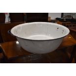 A large enamel wash bowl in blue and white