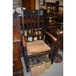 A traditional oak rail back carver chair