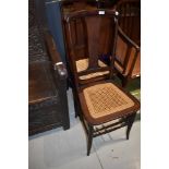 A pair of traditional stained frame cane seated bedroom chairs