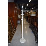A vintage white painted standard lamp