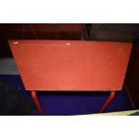 A red laminate topped childrens craft or work table standing aprox 60cm
