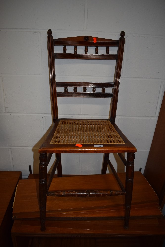 A Victorian stained frame bedroom chair having canework seat
