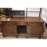 An antique sideboard having continental possibly French influence decorated with Norman style carved