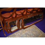 A set of four mahogany framed full length dress mirrors having carved floral decoration