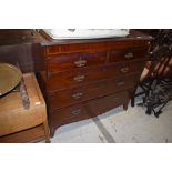 A late Victorian mahogany chest of two over three drawers, having Aesthetic movement style