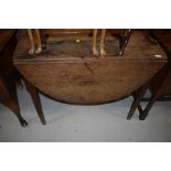 A 19th Century oak drop leaf table on tapered legs, width approx. 93cm