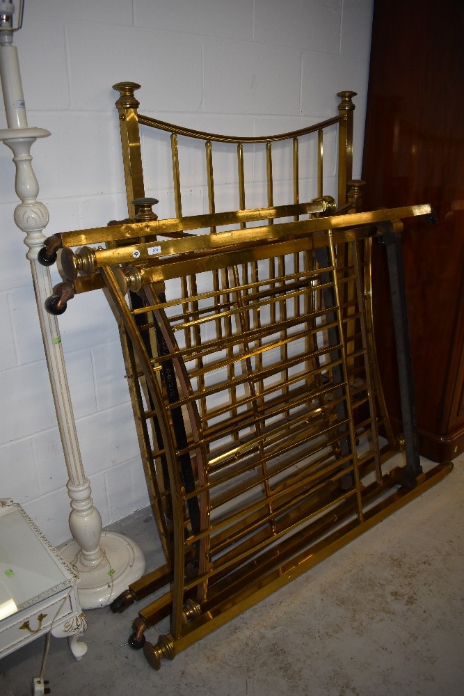 Three antique brass single beds, with decorative irons