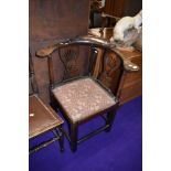 An early 20th Century stained frame corner elbow chair