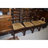 A set of four vintage stained frame ladder back chairs