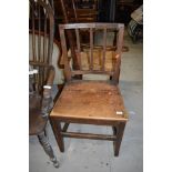 A 19tbh Century oak solid seat and rail back dining chair