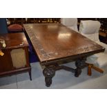 An early 20th Century oak drawer leaf table, by Waring and Gillow, having lunette carved