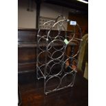 A stainless steel wire work wine rack