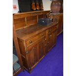 An early 20th Century oak sideboard, having ledge back and linen fold doors, width approx. 139cm