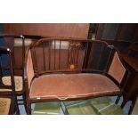 An Edwardian mahogany and inlaid salon settee, some damage and repair to shoulders