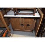 A vintage kitchen or industrial cabinet, having enamelled top, and vented double cupboard under