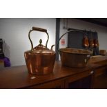 A traditional copper kettle and brass jam pan