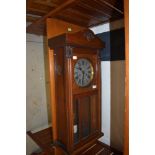 An early 20th Century mahogany cased wall clock, height approx. 77cm